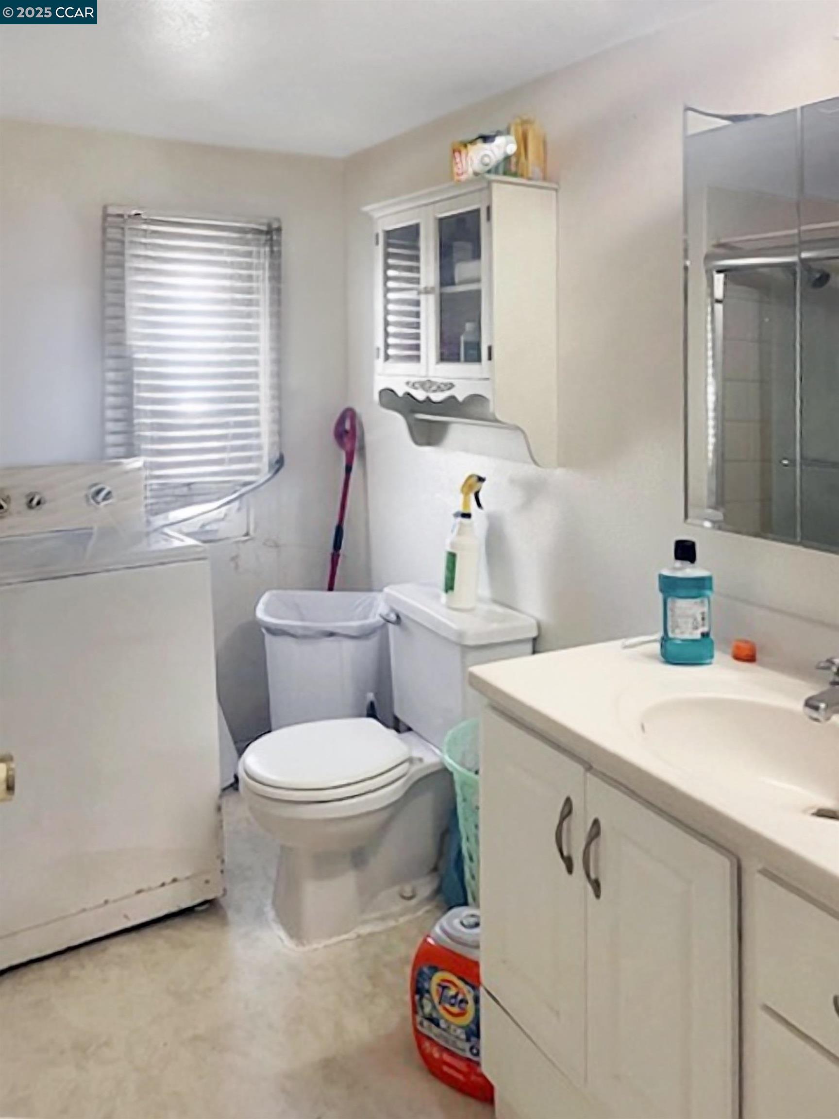 841 West Brannan Island Road, Unit 5 Isleton, CA 95641 - Photo 10 of 22 a bathroom with a sink toilet vanity and window