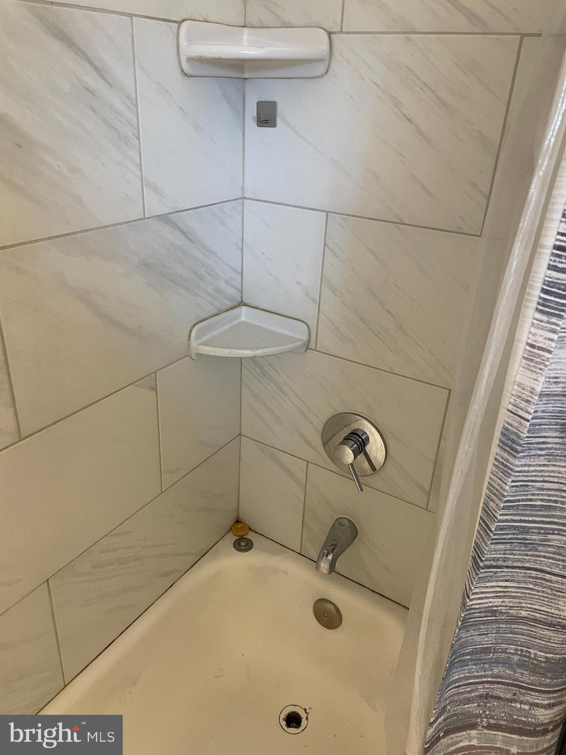 2307 Wyngate Road Suitland, MD 20746 - Photo 13 of 22 a bathroom with a sink and shower
