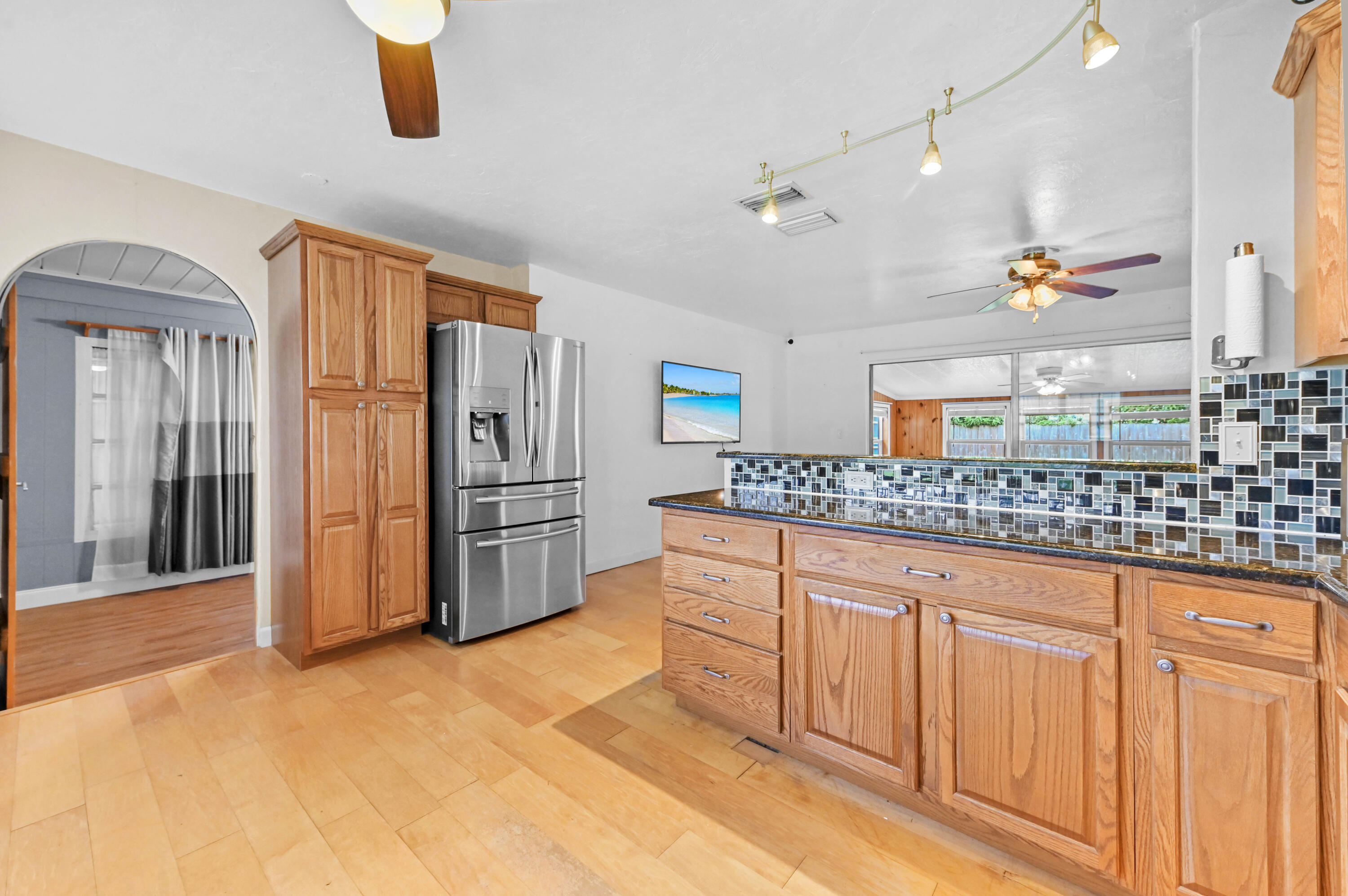 5709 Southeast Indigo Avenue Stuart, FL 34997 - Photo 6 of 26 a kitchen with stainless steel appliances granite countertop a refrigerator and a sink