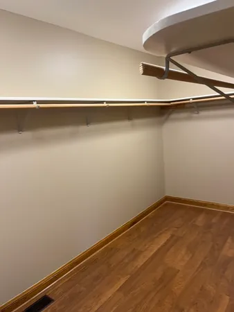 a view of a room with wooden floor