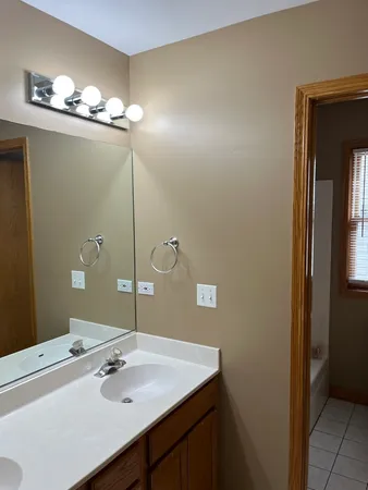 a bathroom with a sink vanity and a mirror