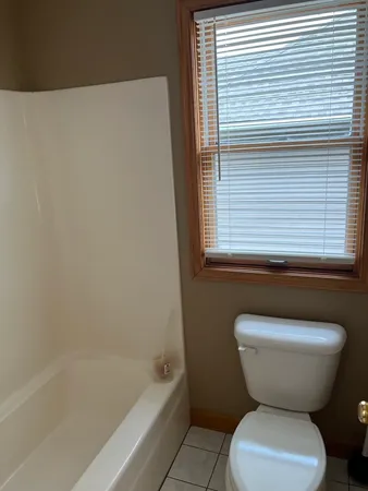 a bathroom with a toilet and bathtub