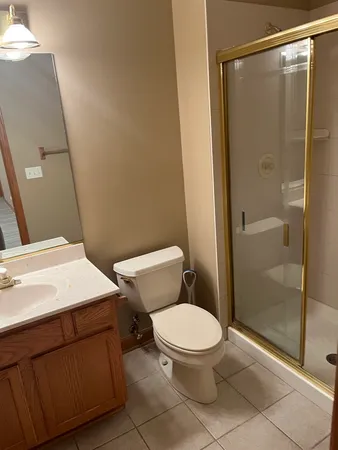 a bathroom with a toilet a sink and shower