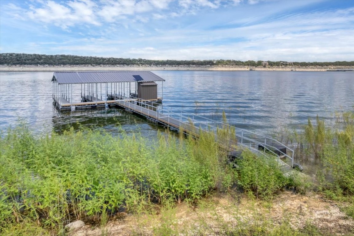 1519 Chipmunk Road Austin, TX 78734 - Photo 2 of 20 a backyard of a house with lots of green space and lake view
