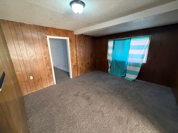 a view of an empty room with a fireplace
