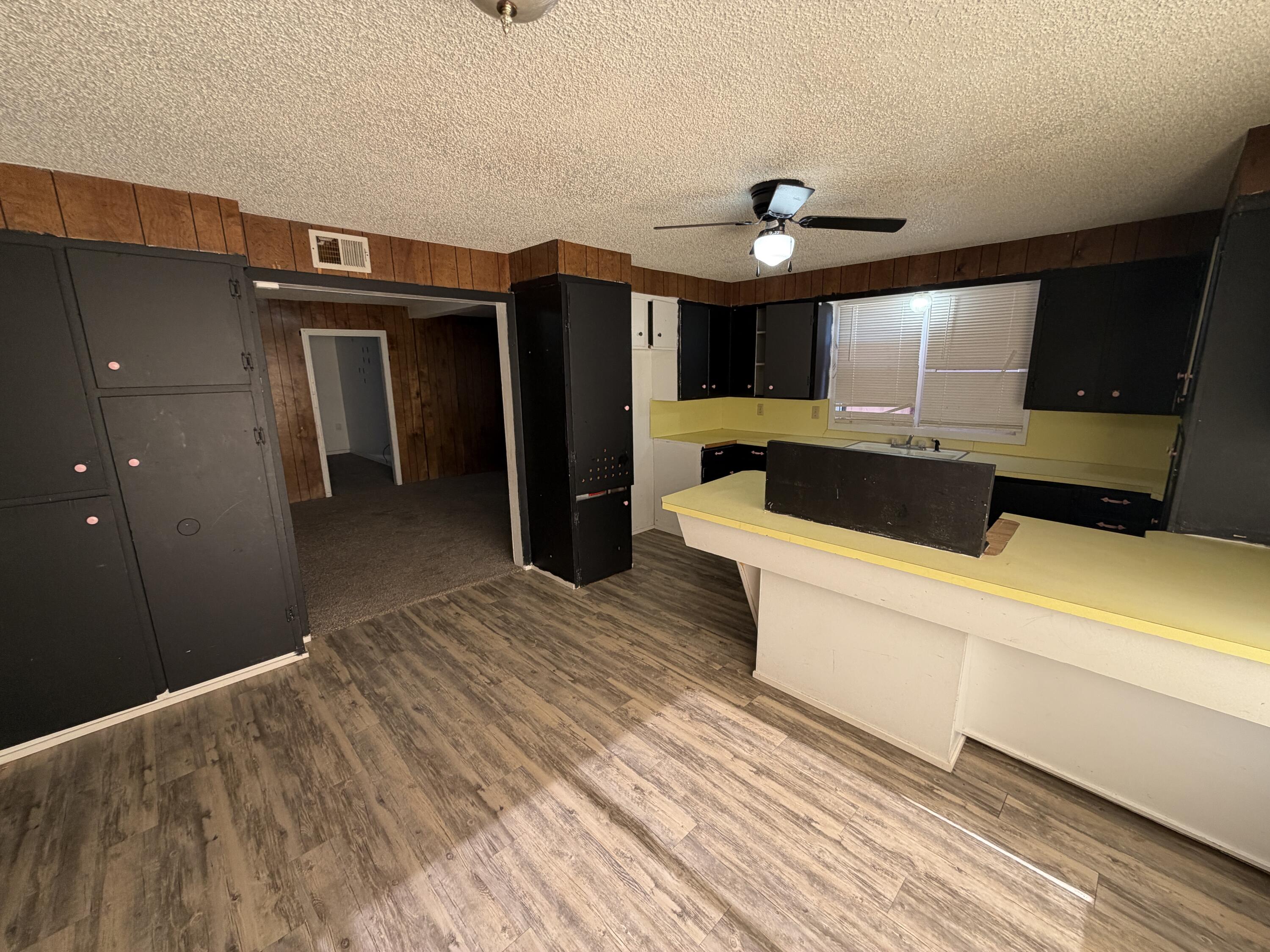 1705 West 16th Street Plainview, TX 79072 - Photo 5 of 13 a kitchen with stainless steel appliances kitchen island a refrigerator sink and cabinets