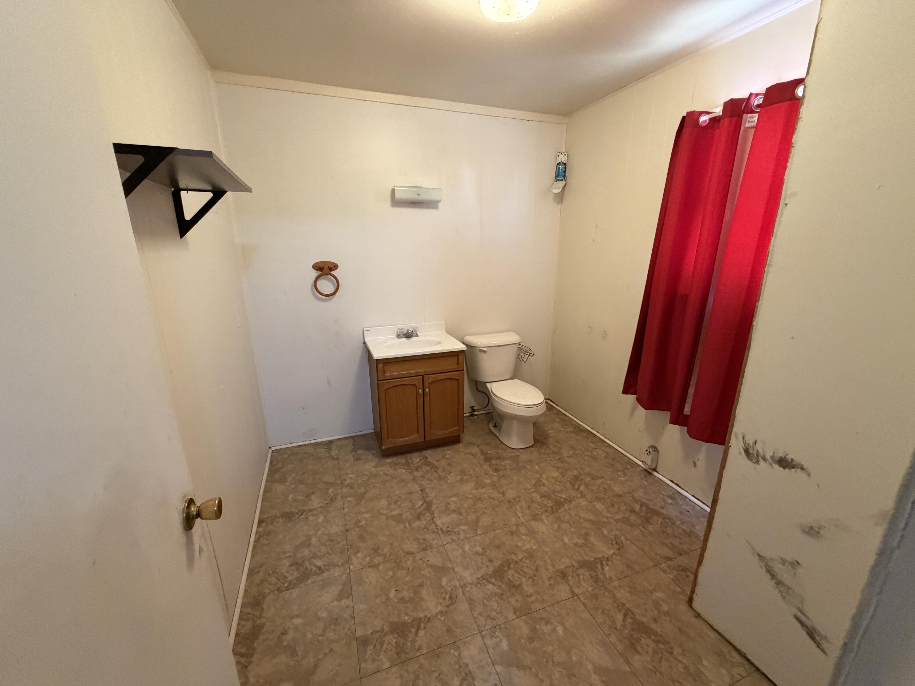 1705 West 16th Street Plainview, TX 79072 - Photo 7 of 13 a bathroom with a sink and a toilet