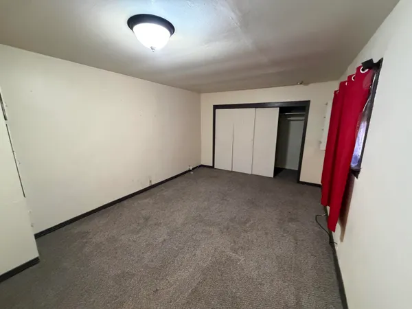 an empty room with a flat screen tv