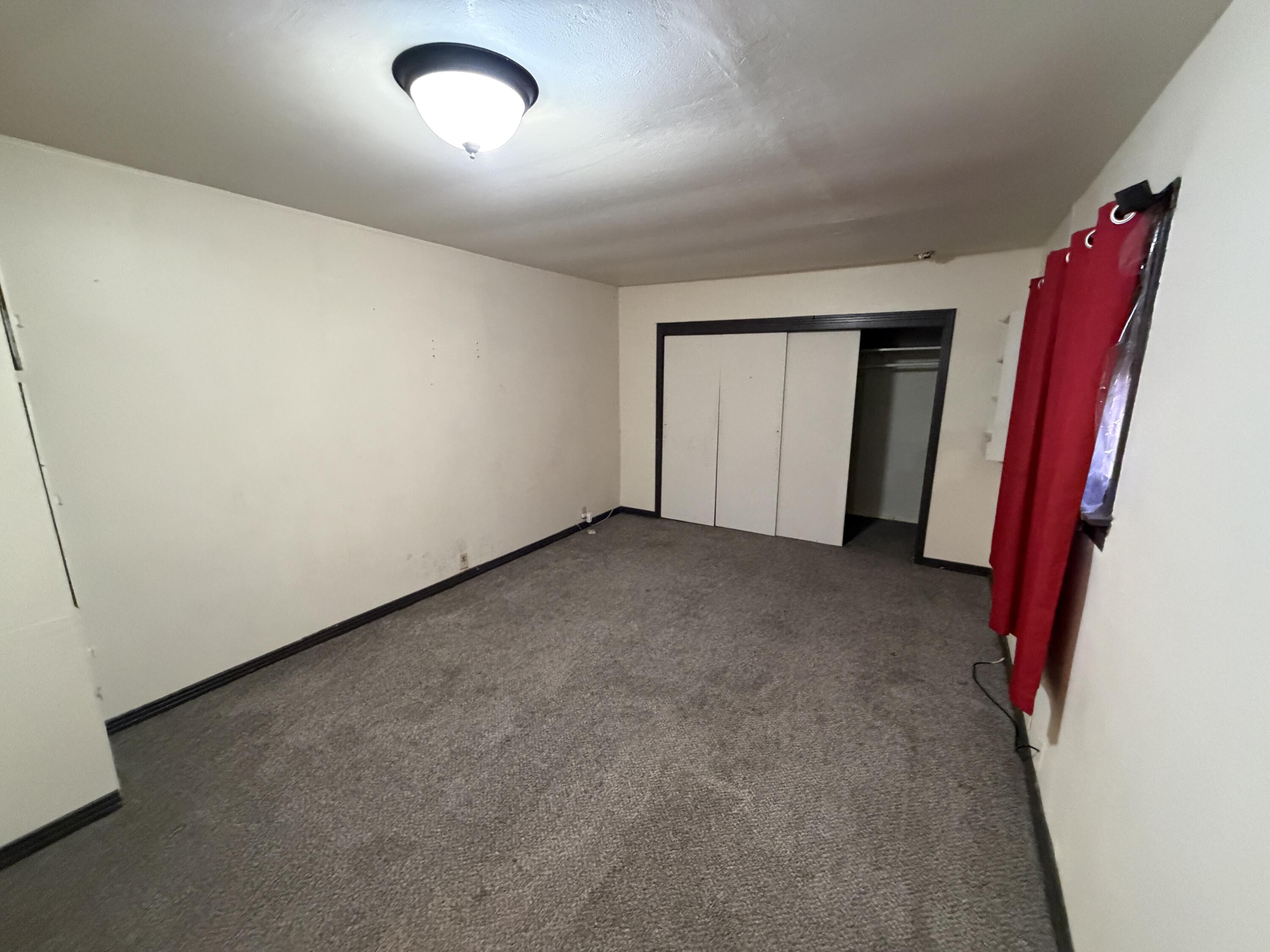 1705 West 16th Street Plainview, TX 79072 - Photo 8 of 13 an empty room with a flat screen tv