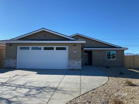 1629 Mayo Street Ridgecrest, CA 93555 - Photo 5 of 25 a front view of a house with a garage