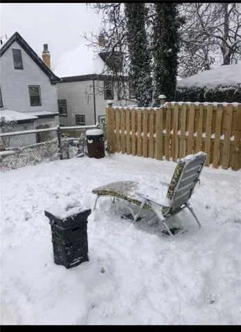 a view of backyard with wooden fence