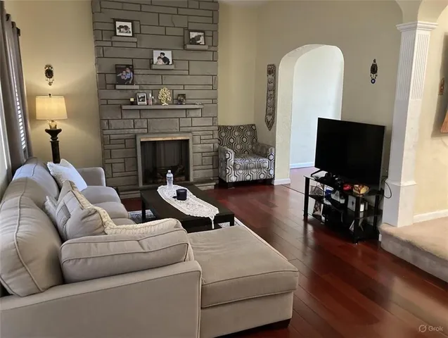 a living room with furniture and a fireplace