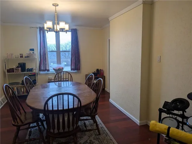 a view of a dining room with furniture and chandelier