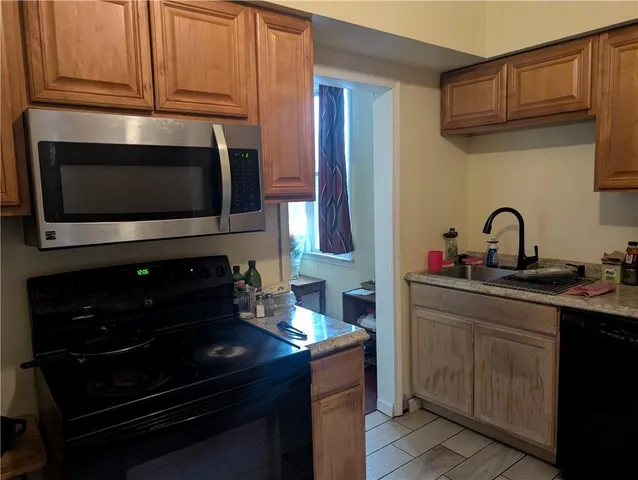 a kitchen with stainless steel appliances a stove and a microwave