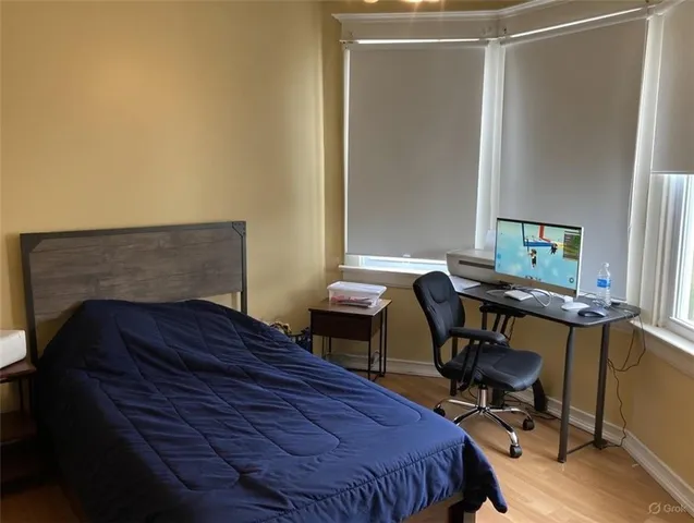 a bedroom with a bed and a desk