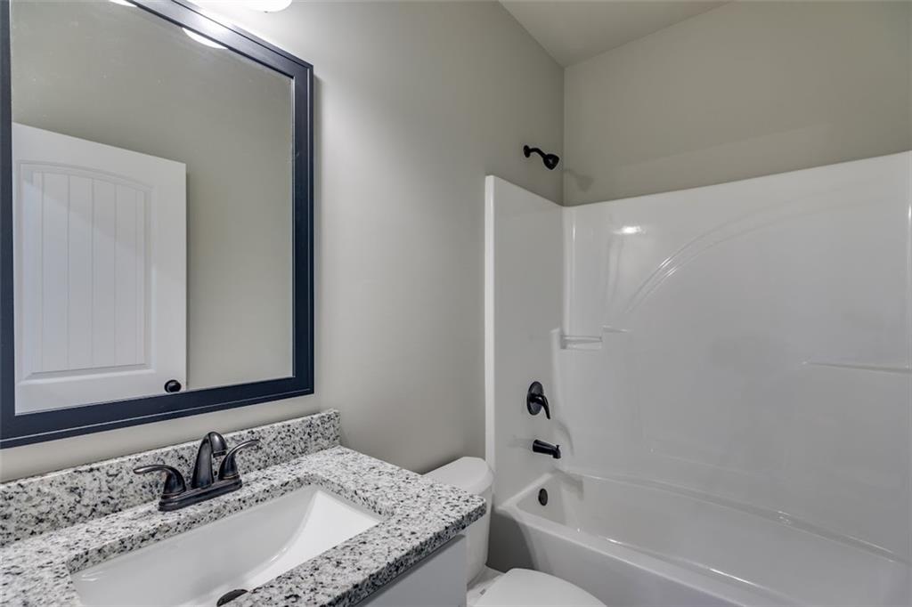466 Mt Zion Church Road Tallapoosa, GA 30176 - Photo 26 of 35 a bathroom with a granite countertop tub sink and mirror