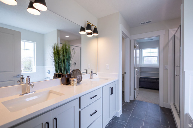 209 North 1140 West Mapleton, UT 84664 - Photo 11 of 21 Full bath featuring a shower stall, double vanity, and dark tile patterned floors