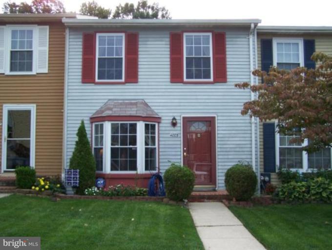 a front view of brick house with a yard