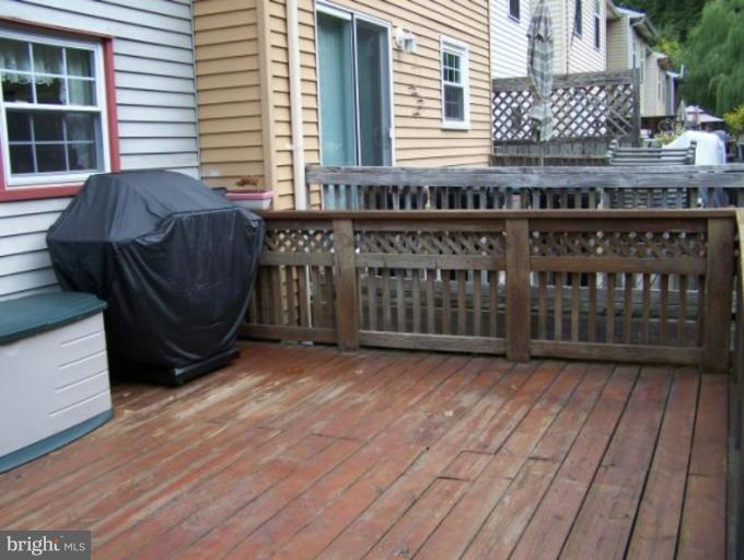 4005 Rustico Road Middle River, MD 21220 - Photo 3 of 20 a view of a porch with wooden floor and fence
