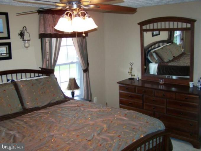 4005 Rustico Road Middle River, MD 21220 - Photo 10 of 20 a bedroom with a bed and dresser with mirror