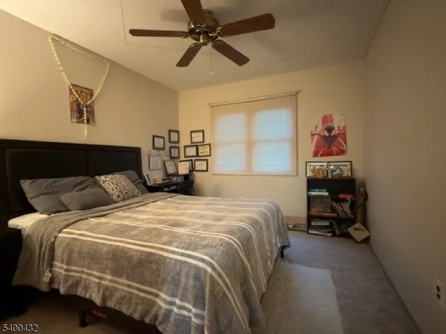 a bedroom with a bed and a tv