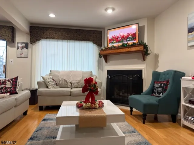 a living room with furniture a rug and a fireplace