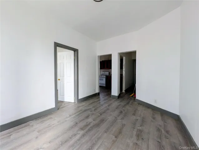 an empty room with closet and a window