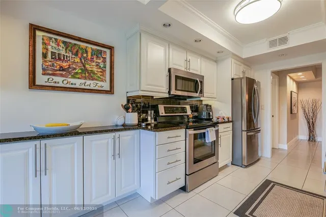 a bedroom with a bed and painting on the wall
