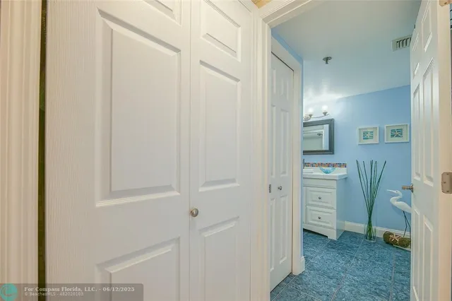 a view of a patio with a table and chairs under an umbrella