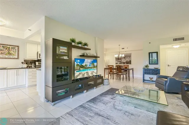 a view of a dining room with furniture and a chandelier