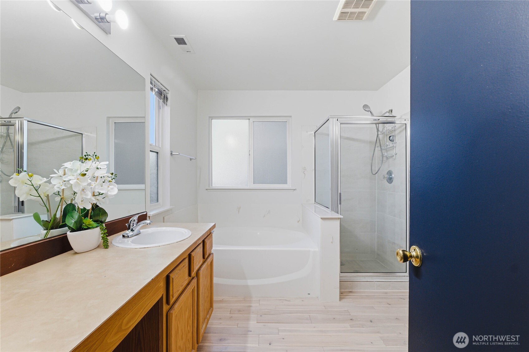 2513 Northeast 2nd Street Renton, WA 98056 - Photo 23 of 38 a bath room with a sink double vanity granite tub shower and a mirror