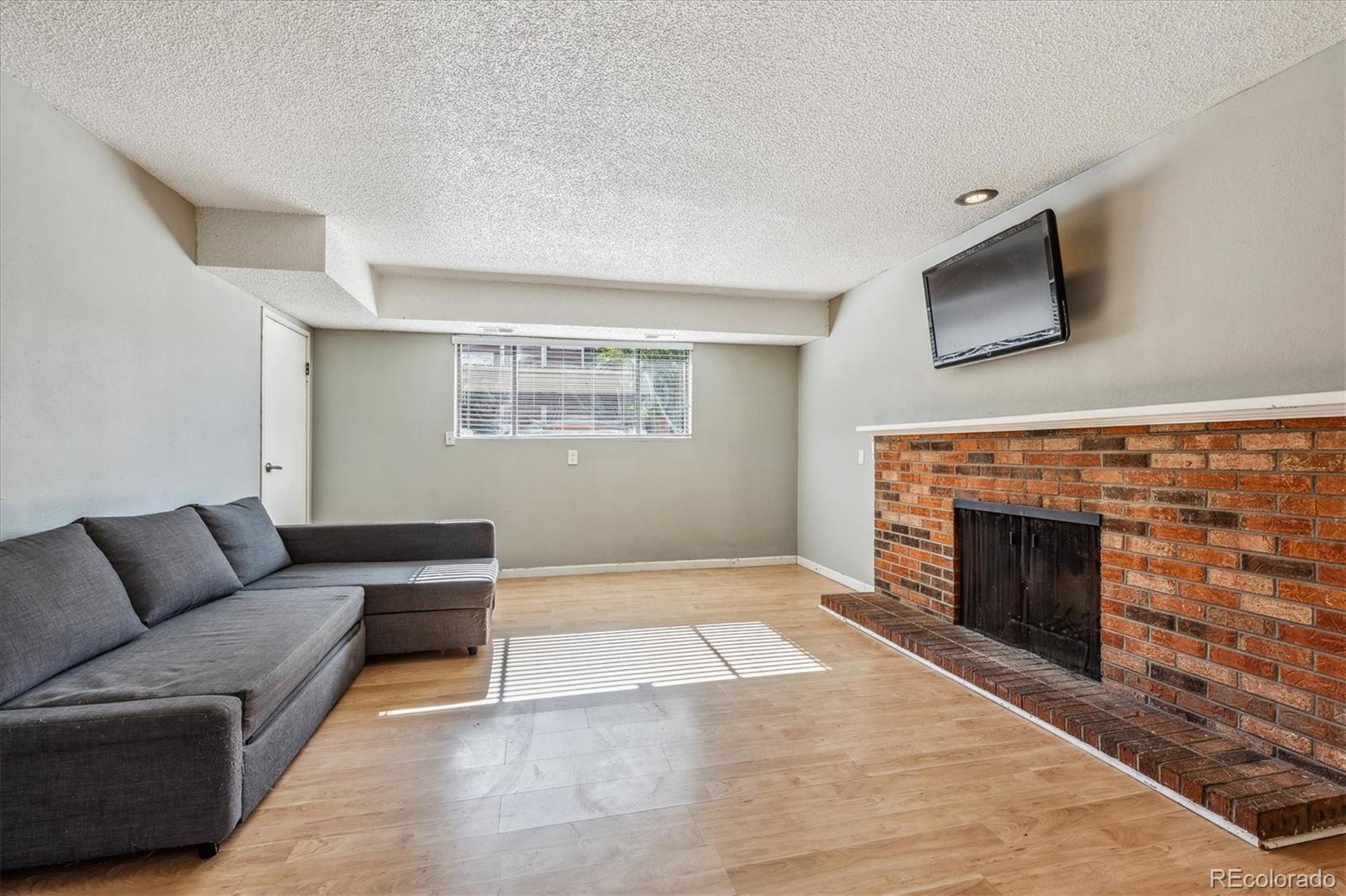 2141 Baseline Road, Unit 4 Boulder, CO 80302 - Photo 12 of 22 a living room with furniture and a fireplace