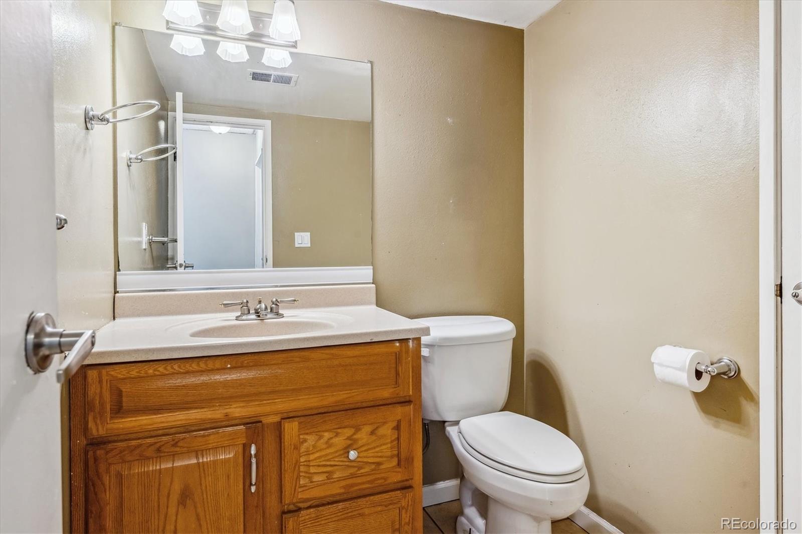 2141 Baseline Road, Unit 4 Boulder, CO 80302 - Photo 16 of 22 a bathroom with a granite countertop toilet sink and mirror