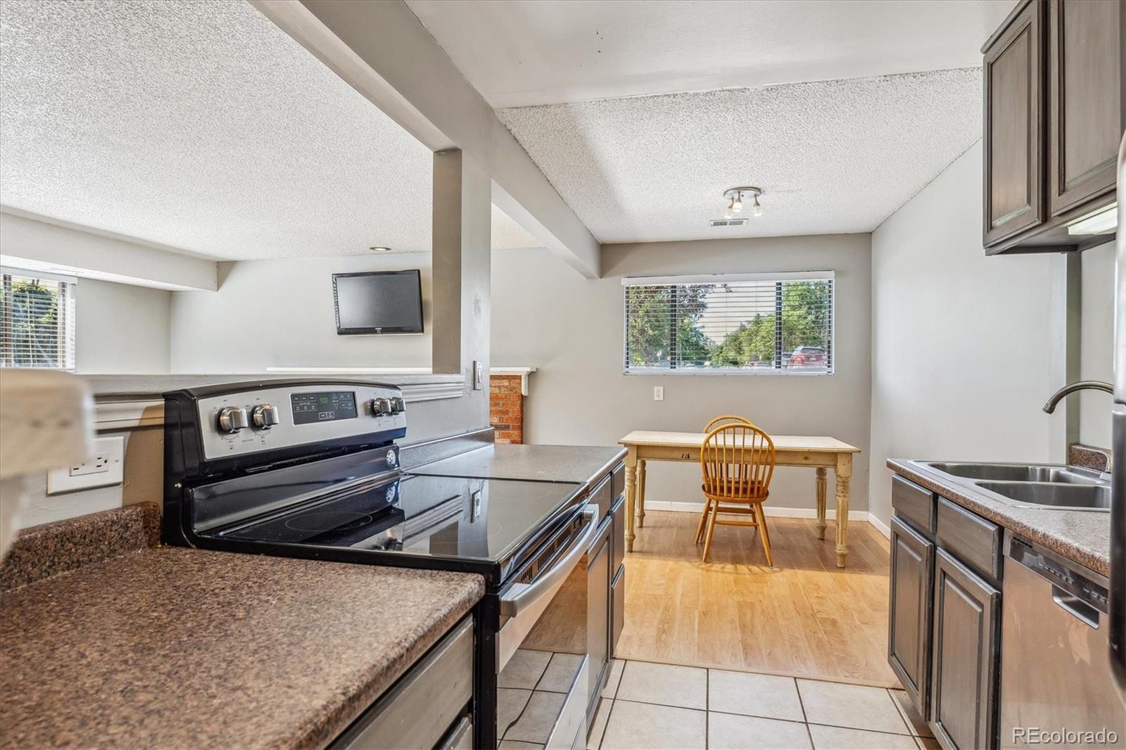 2141 Baseline Road, Unit 4 Boulder, CO 80302 - Photo 9 of 22 a kitchen with stainless steel appliances granite countertop a stove a sink and a refrigerator