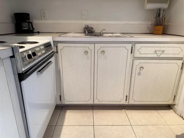 a kitchen with a stove and a refrigerator