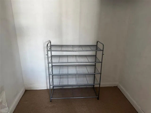 a bedroom with a bed a couch and a large window