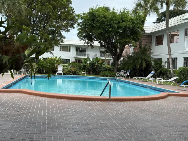 a car parked in front of a brick house