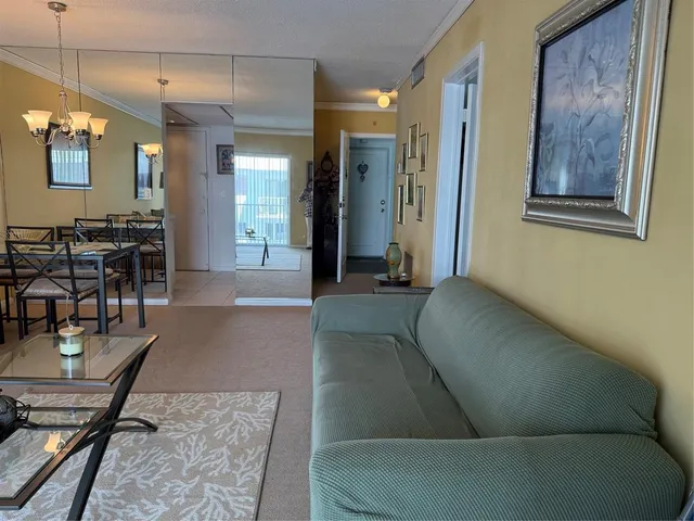 a living room with furniture and a chandelier