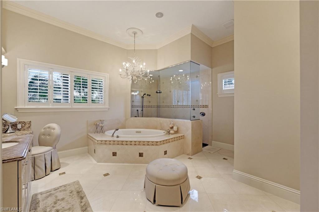 361 Pirates Bight Naples, FL 34103 - Photo 21 of 45 a bathroom with a granite countertop toilet a sink and a bathtub