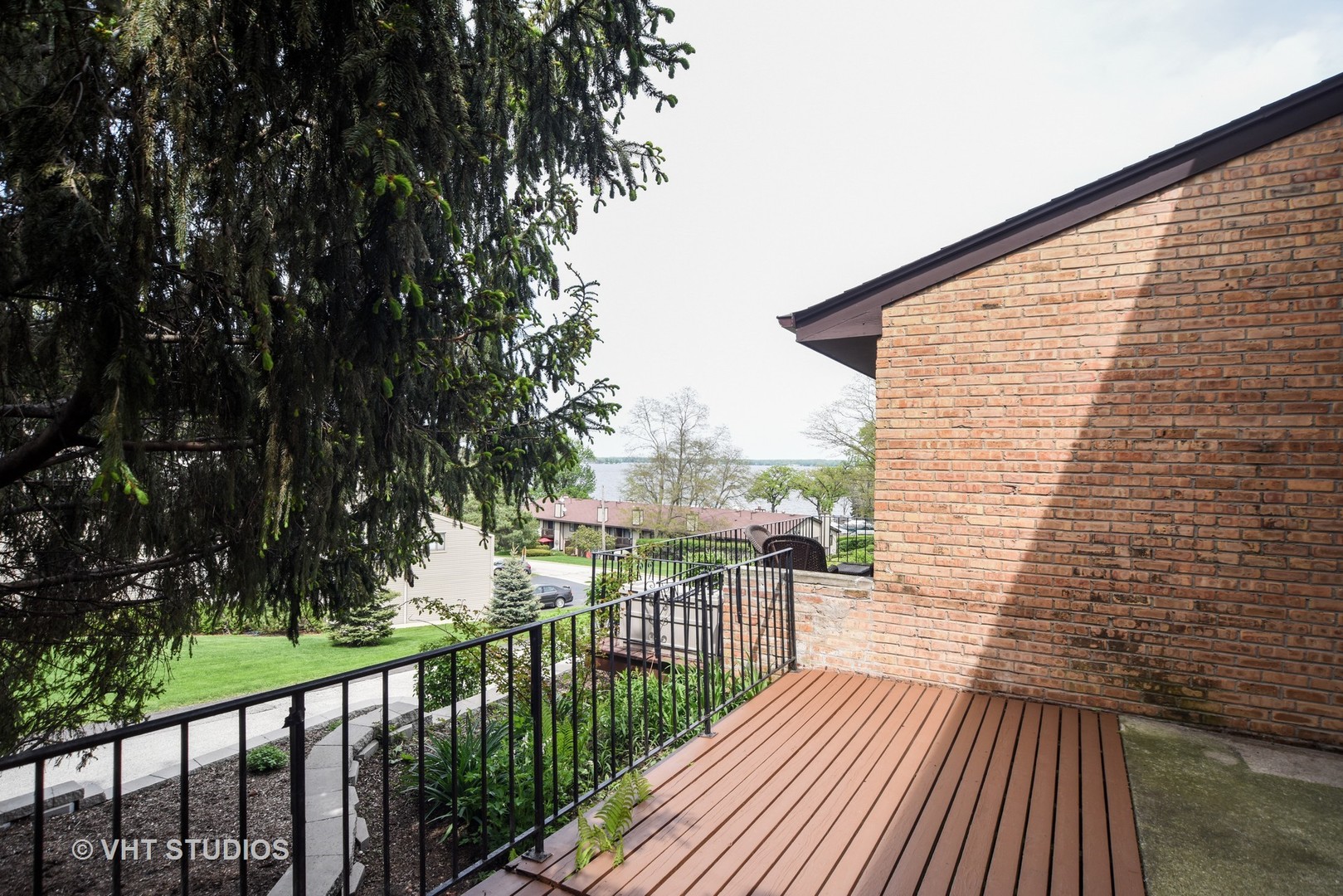 77 Mineola Road, Unit 77 Fox Lake, IL 60020 - Photo 2 of 24 a view of a balcony with wooden floor