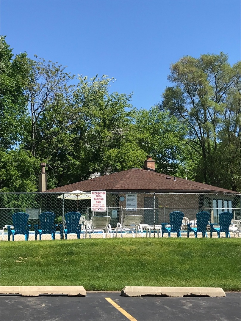 77 Mineola Road, Unit 77 Fox Lake, IL 60020 - Photo 13 of 24 a front view of a house with a garden
