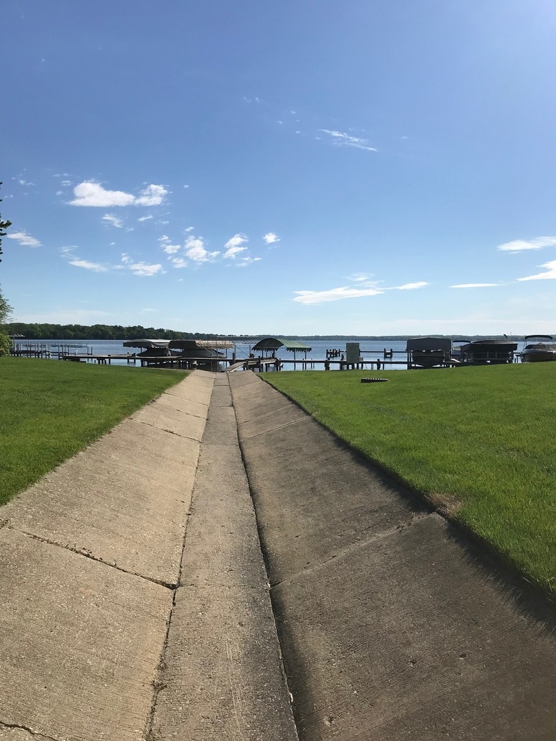 77 Mineola Road, Unit 77 Fox Lake, IL 60020 - Photo 16 of 24 a view of a lake with outdoor space