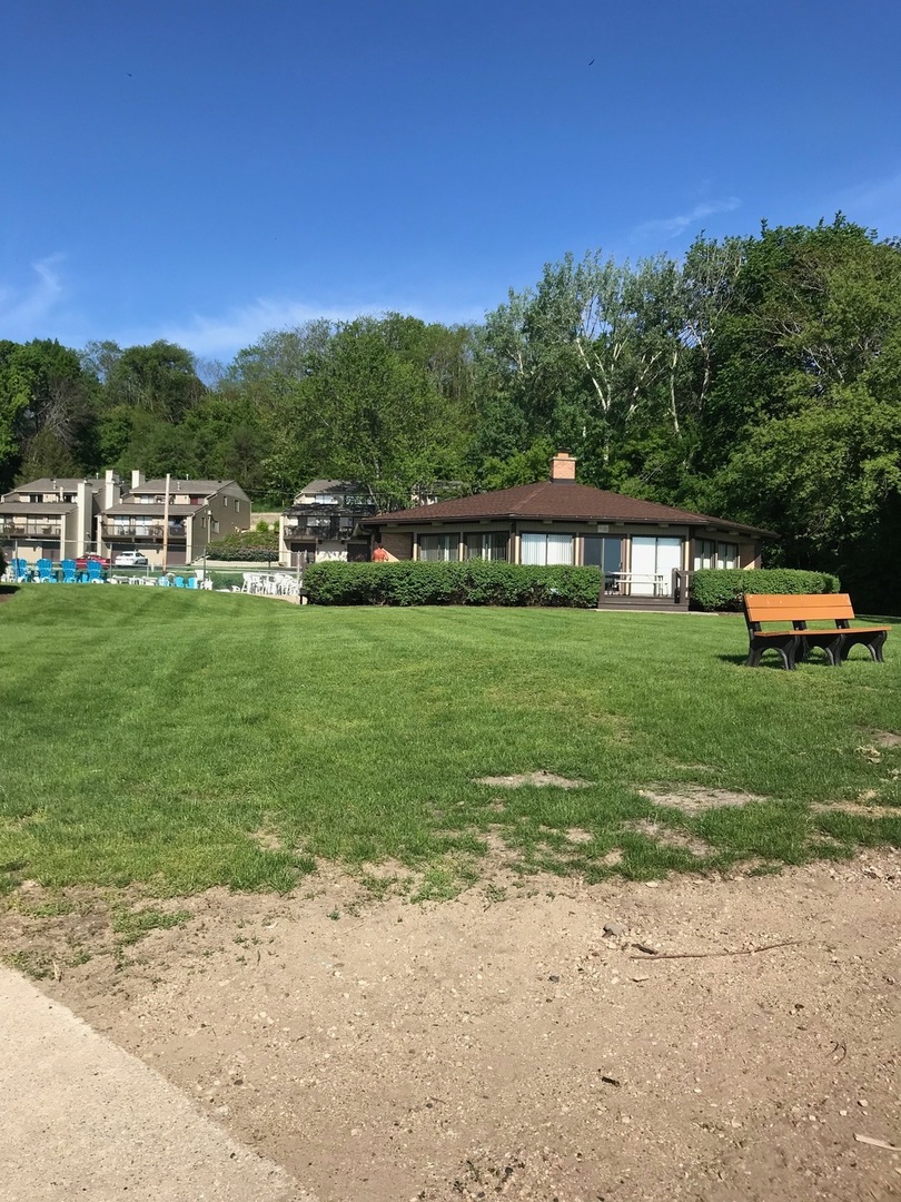 77 Mineola Road, Unit 77 Fox Lake, IL 60020 - Photo 19 of 24 a view of a house with a big yard