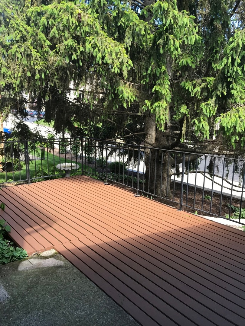 77 Mineola Road, Unit 77 Fox Lake, IL 60020 - Photo 3 of 24 a street view with wooden fence