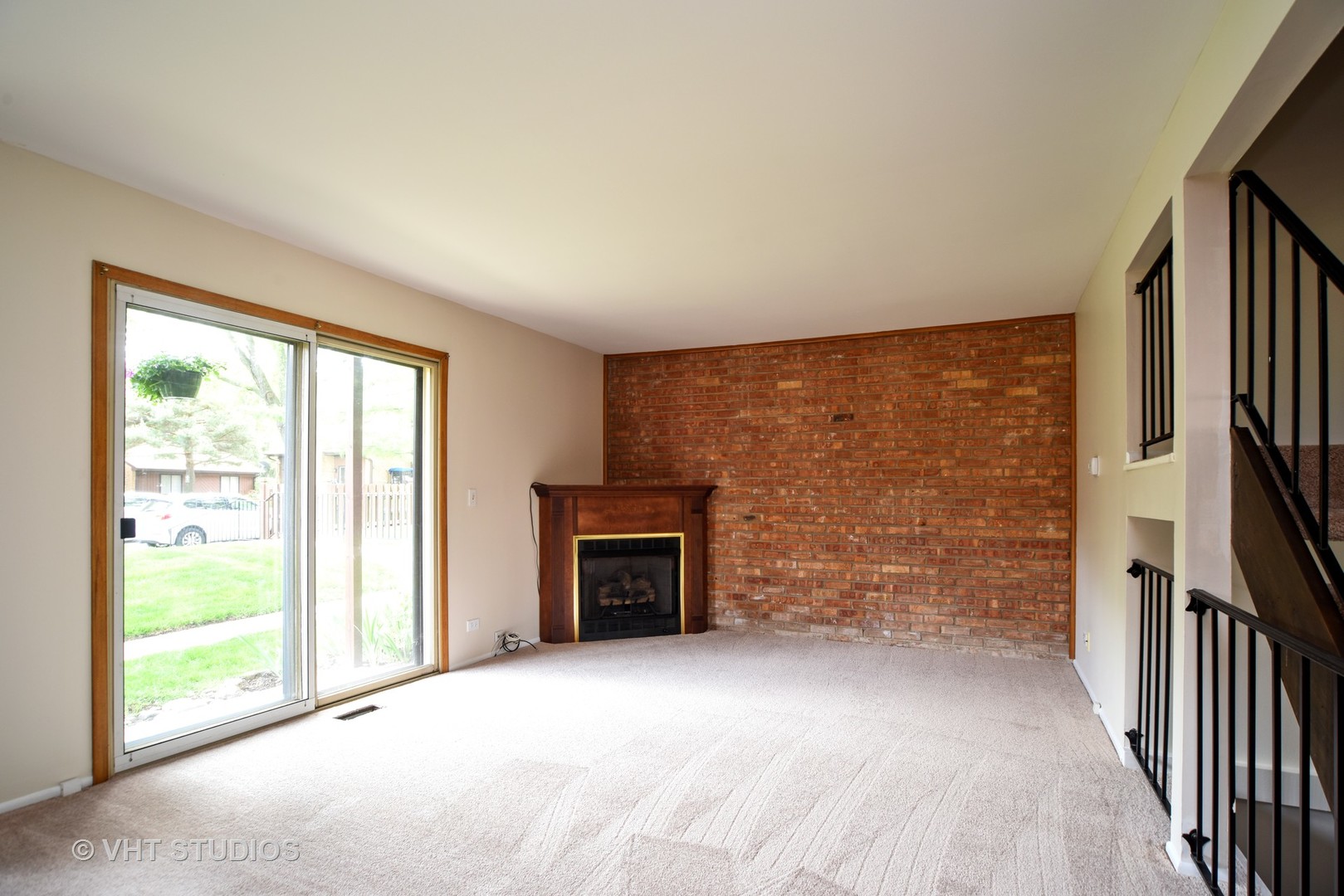 77 Mineola Road, Unit 77 Fox Lake, IL 60020 - Photo 5 of 24 a view of an empty room with a fireplace and a window