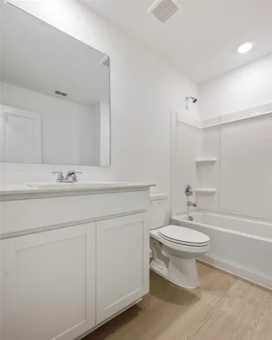 an empty room with windows and refrigerator