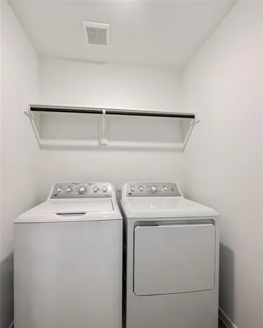 a view of a backyard with large tree and wooden fence