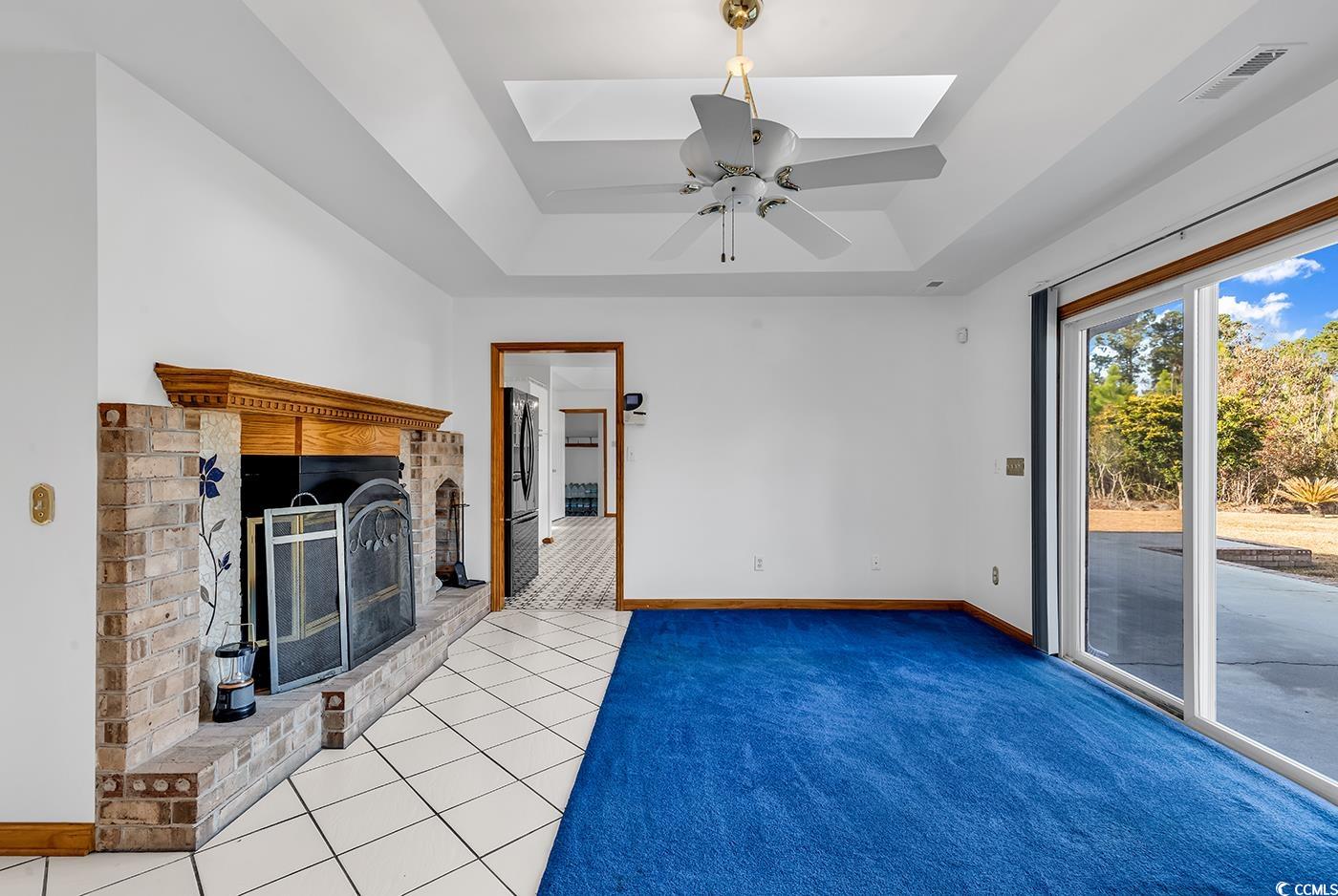 5938 Rahnavard Boulevard Myrtle Beach, SC 29588 - Photo 13 of 39 Unfurnished living room featuring a skylight, ceil