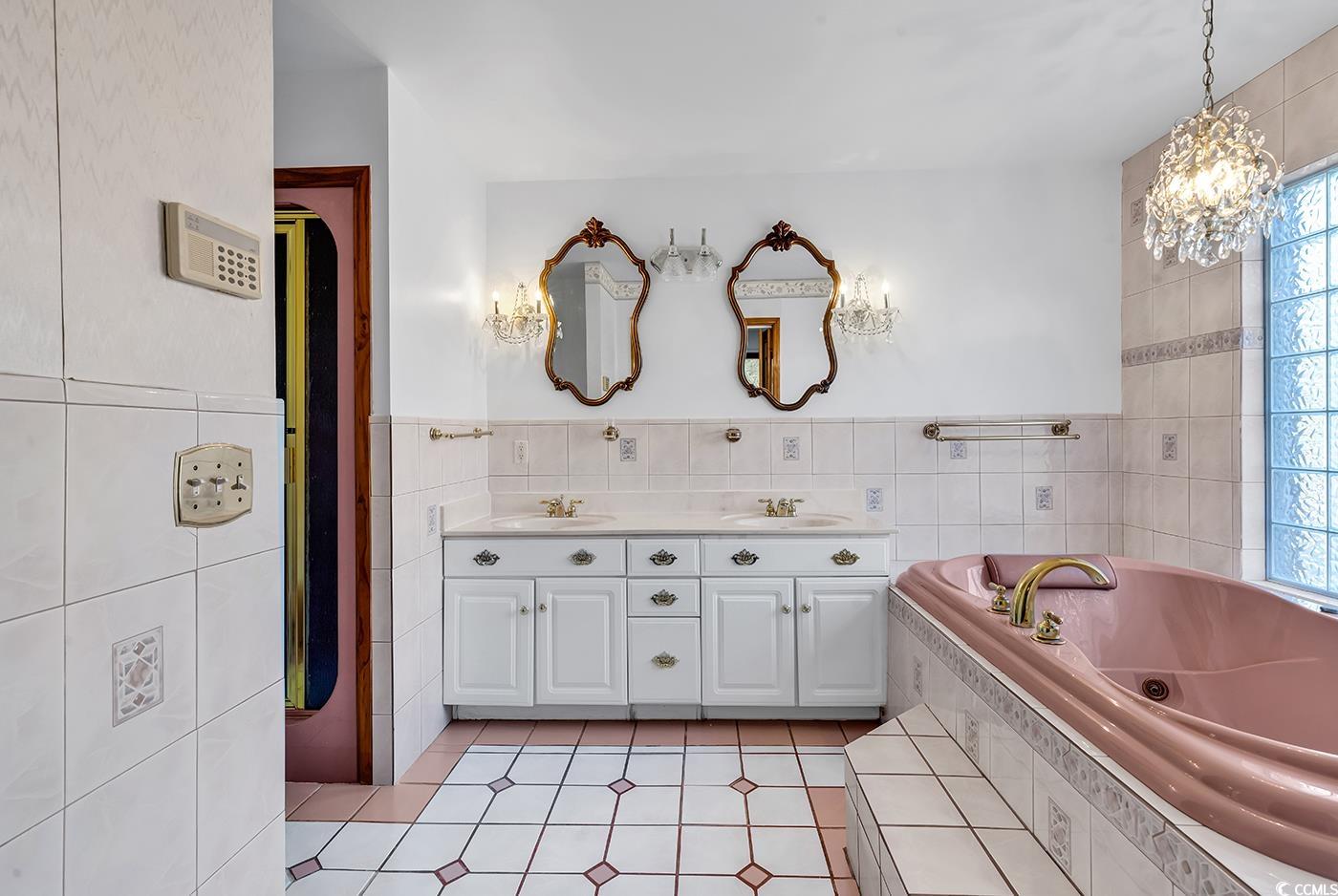 5938 Rahnavard Boulevard Myrtle Beach, SC 29588 - Photo 18 of 39 Bathroom featuring a notable chandelier, vanity, t