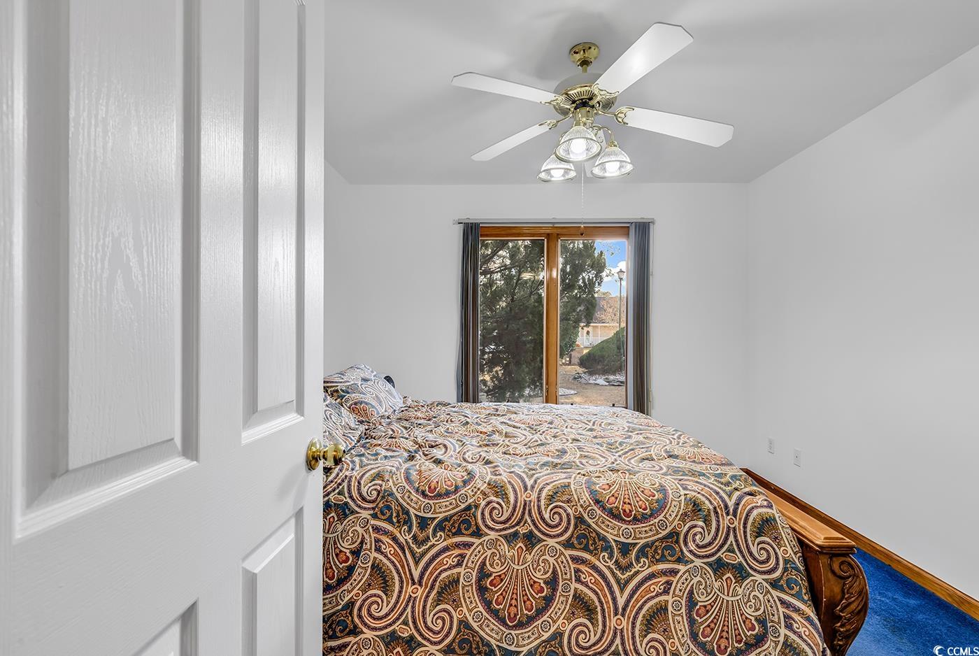 5938 Rahnavard Boulevard Myrtle Beach, SC 29588 - Photo 21 of 39 Carpeted bedroom with ceiling fan